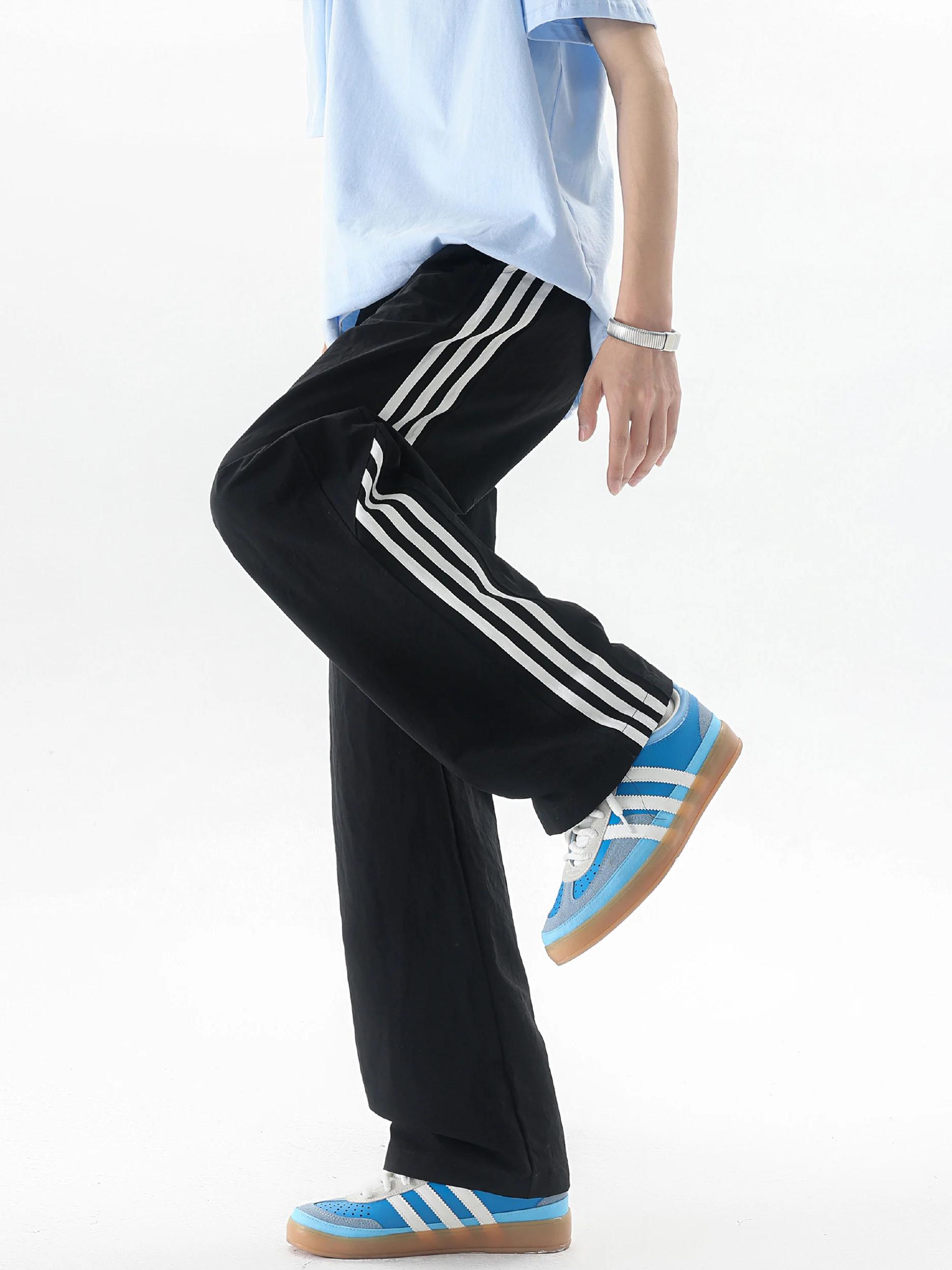 推荐商品：NXNM 冰丝垂感速干印花透气侧边条纹针织长裤 NXY-KZ048 黑